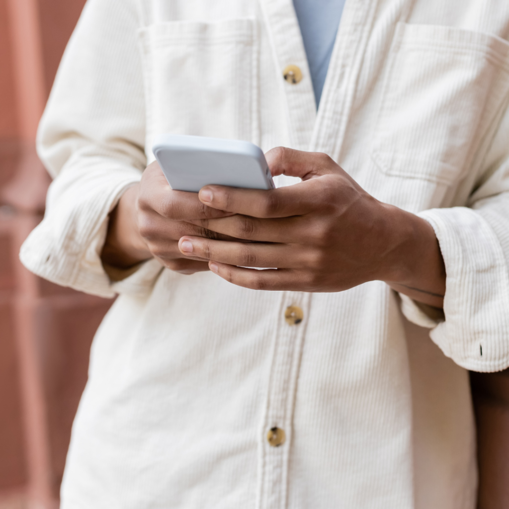 Girl checking her phone for the new patient checklist at Smile Perfections dentist Leicester, preparing for her first dental appointment.