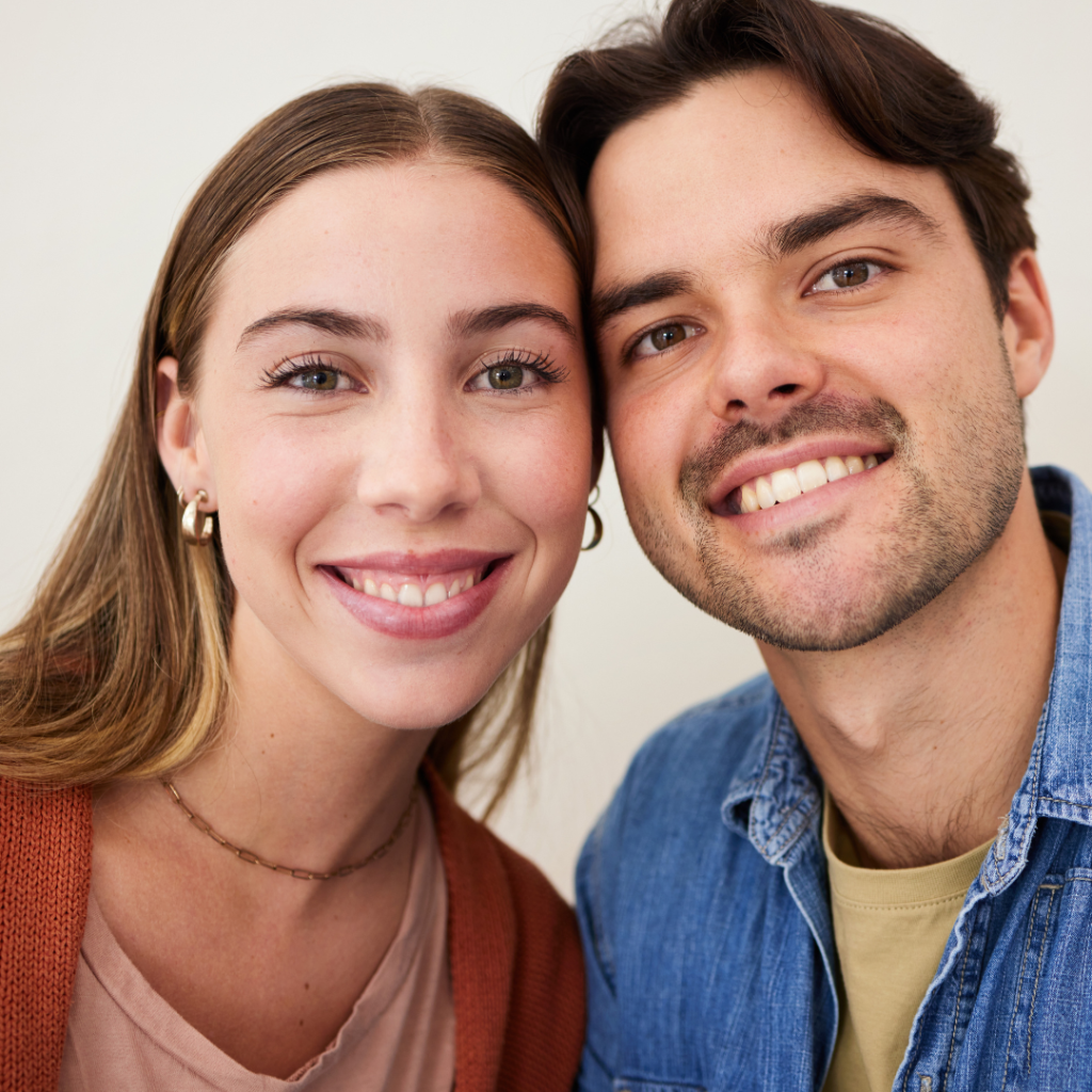 young couple slightly smiling, looking at the camera after his appointment for composite bonding in Oadby