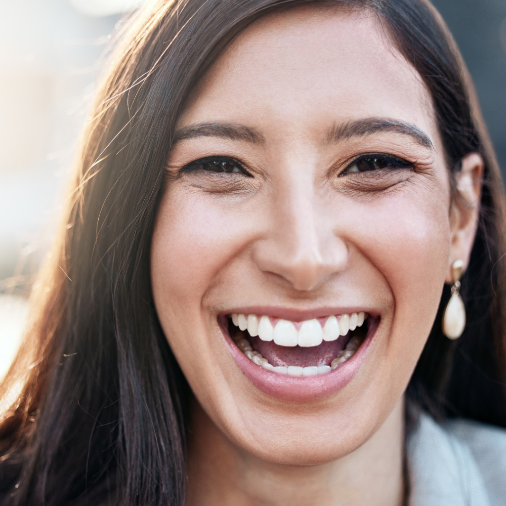 close-up photo of a young business woman representing the result after getting composite bonding at Smile Perfections in Leicester