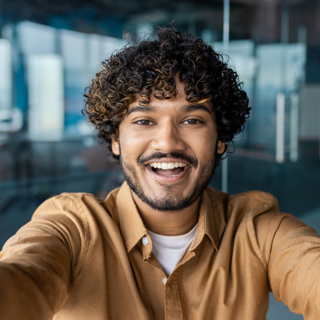 Man smiling and taking a selfie after teeth whitening treatment at Smile Perfections dentist Leicester, showcasing a bright and confident smile.