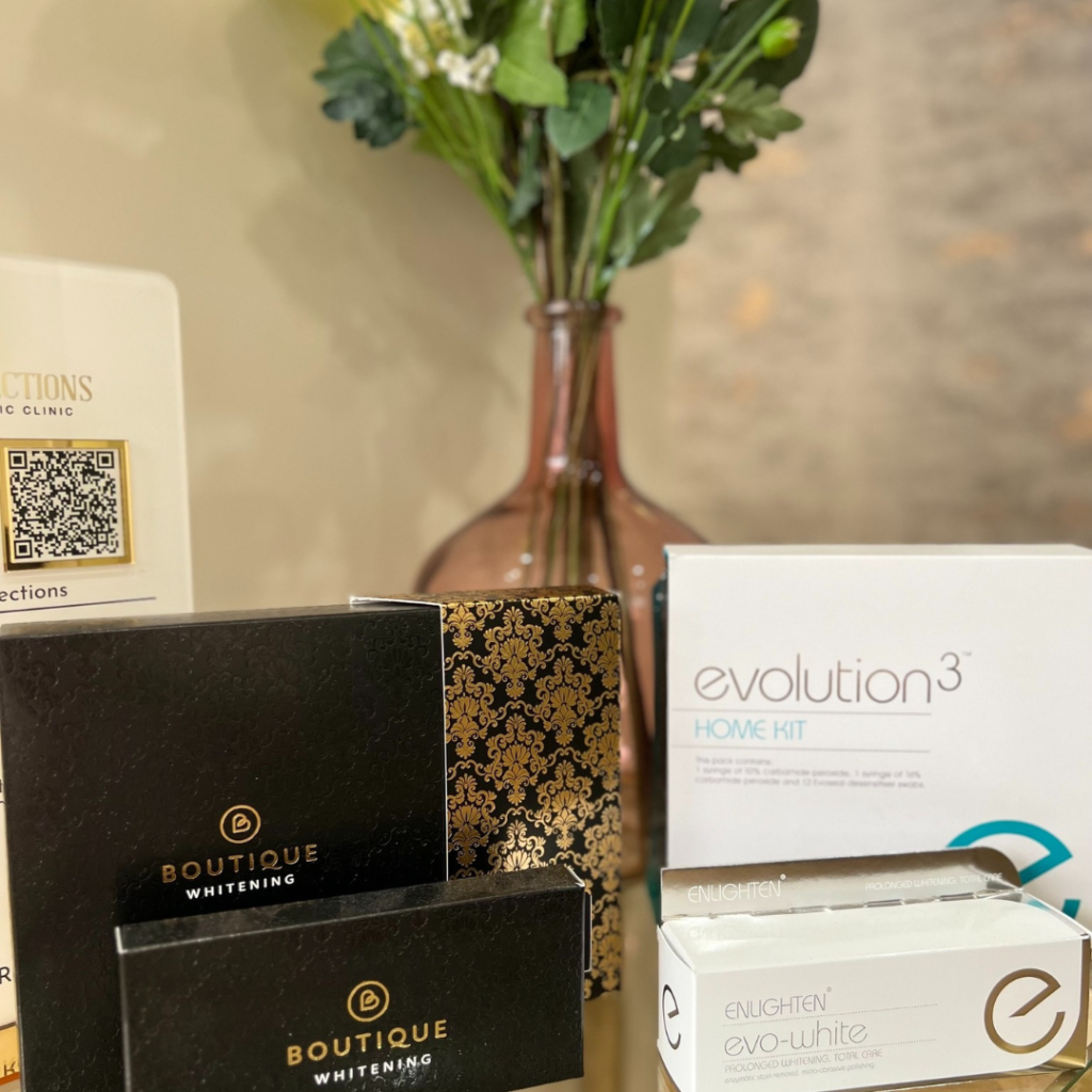 Teeth whitening kits including Boutique and Enlighten provided at Smile Perfections dentist Leicester, showcasing professional at-home whitening options.