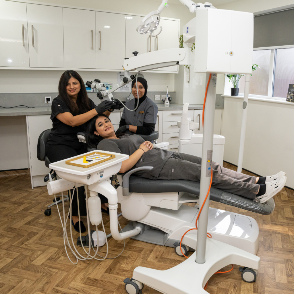 Dr Pratima, Rupinder, and Kaniz in the surgery room at Smile Perfections dentist Leicester, engaging in a consultation-style discussion to demonstrate patient care.