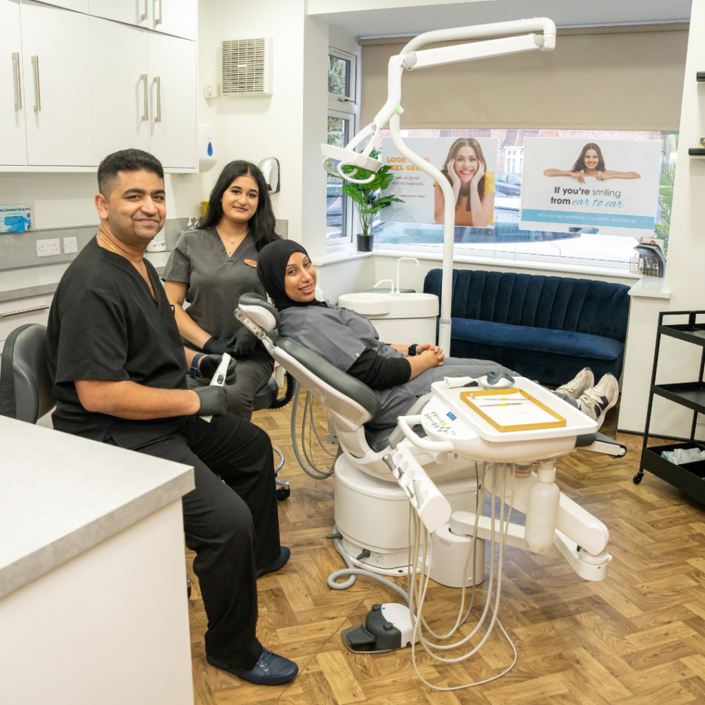 Dr Juttes, Rupinder, and Kaniz in the surgery room at Smile Perfections dentist Leicester, taking photos to document the clinic environment and team collaboration.