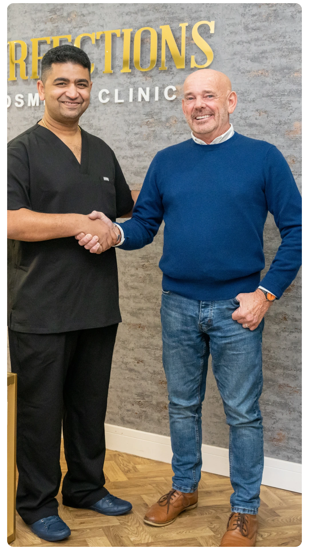 Dr Juttes Pallipatt at Smile Perfections in Leicester shaking hands with a patient at the reception, both smiling after successful dental treatment.