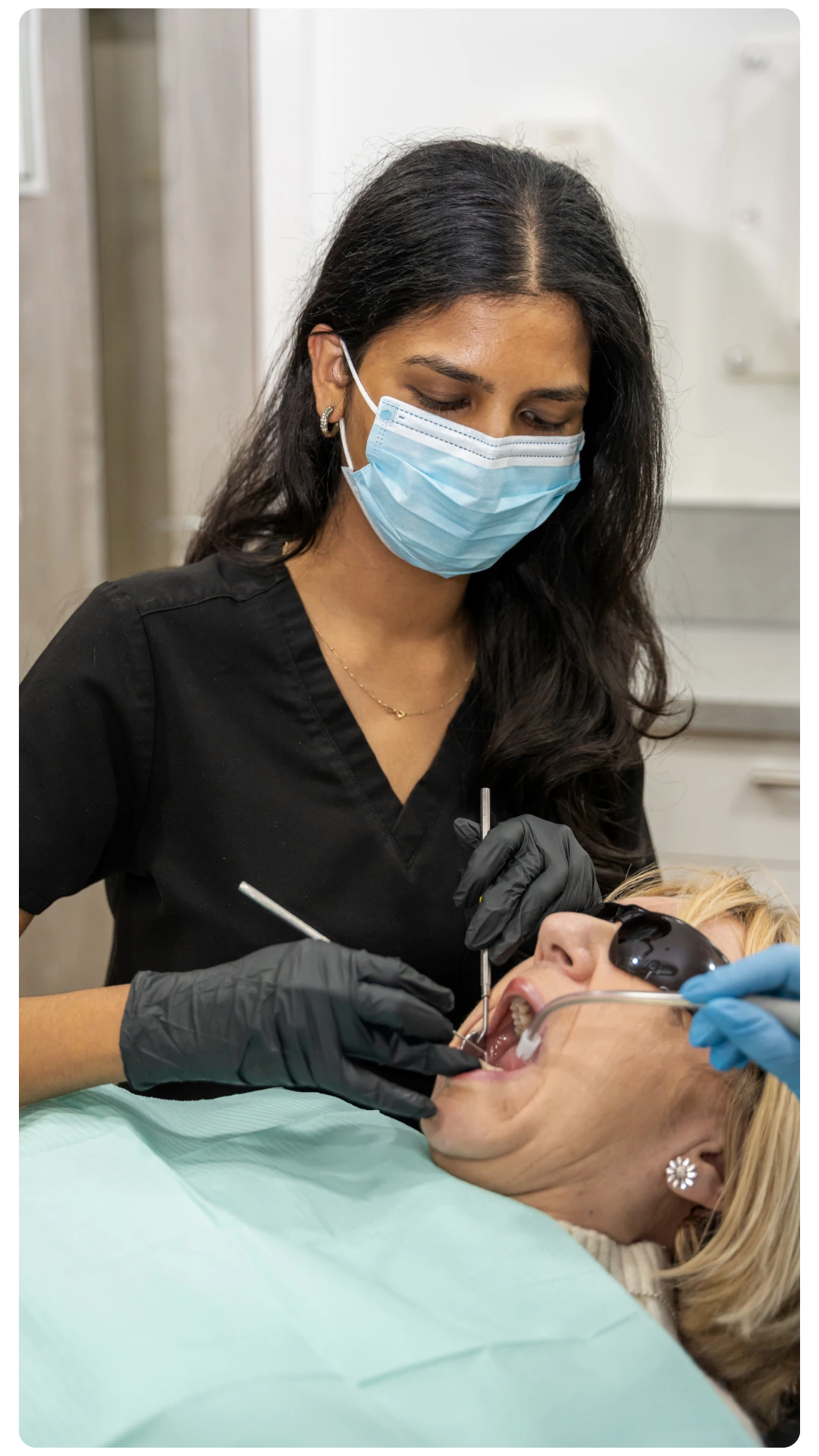 Hygienist at Smile Perfections in Leicester during a hygiene appointment, providing professional cleaning and promoting healthy teeth and gums.