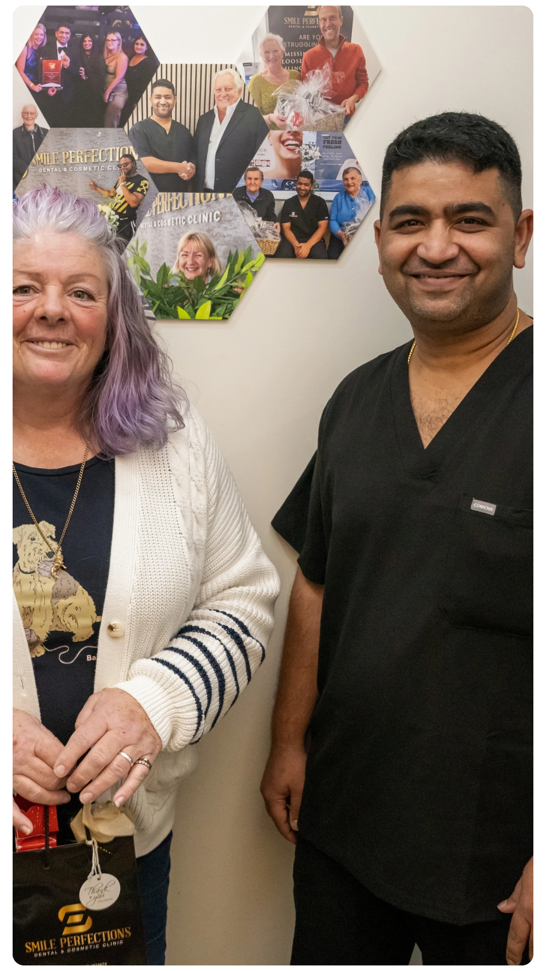Dr Juttes Pallipatt at Smile Perfections in Leicester smiling with a female patient at the reception, reflecting a warm and welcoming dental experience.