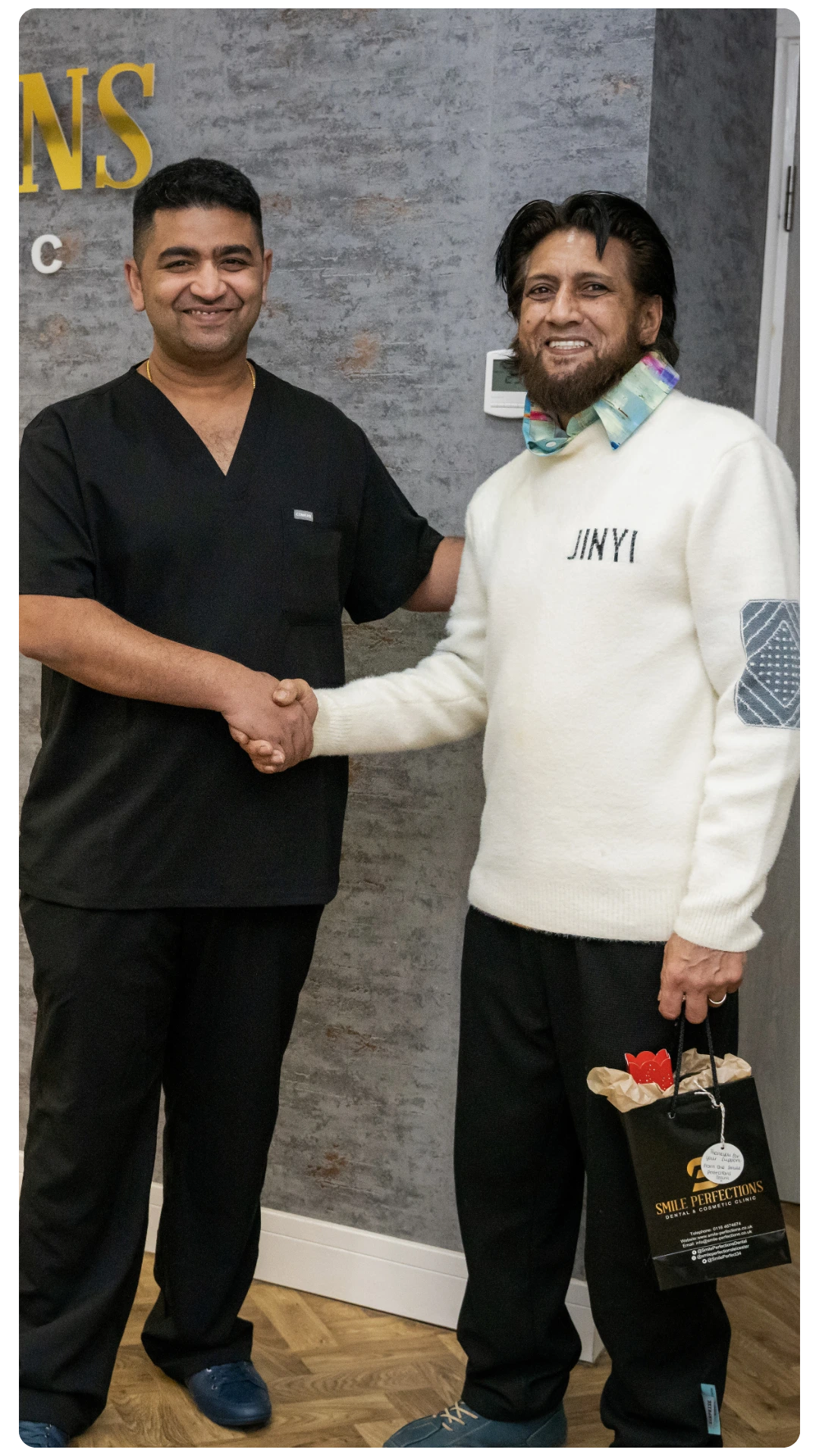 Dr Juttes Pallipatt at Smile Perfections in Leicester shaking hands with a patient, both smiling to reflect trust and satisfaction after dental treatment.