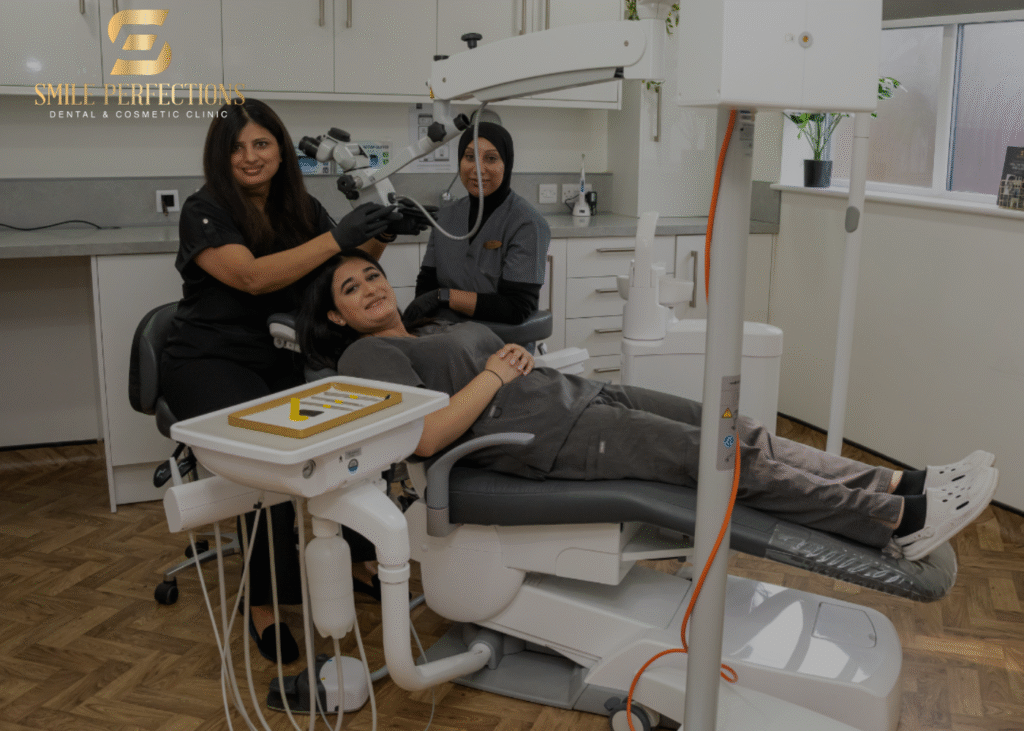 Dr Pratima with dental nurse Kaniz Alli pretending they do a dental check-up on our trainee dental nurse Rupinder, all 3 slightly smiling inside the surgery room